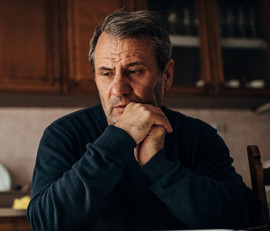 Concerned old man with hands on face